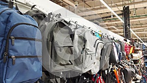 Sale of modern multi-colored backpacks in a store on display, close-up