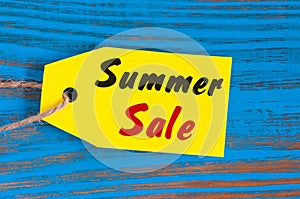 Sale price reduction tag for discounts. Summer sale pricetag at blue background