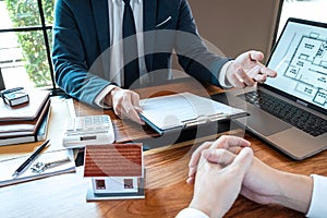 Sale purchase contract to buy a house, Real estate agent are presenting home loan and giving keys to customer after signing