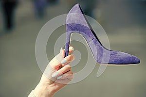 Sale in the shoe. glamour shoe blue color suede on female hand
