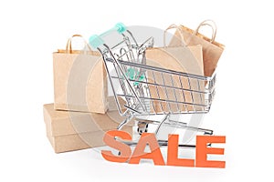 Sale Shopping Concept: Shopping Cart with Paper Bags on White Background