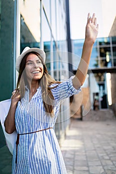 Beautiful woman with shopping bags in the ctiy. Sale, shopping, tourism and happy people concept