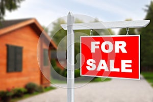 Sale sign near beautiful house outdoors. Red signboard with words