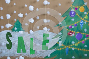 Sale Sign new year. against the background of a painted Christmas tree and snow