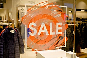 SALE Sign on the shop`s window display.discount sign on show window. Sale sign, symbol in clothes shop,The red