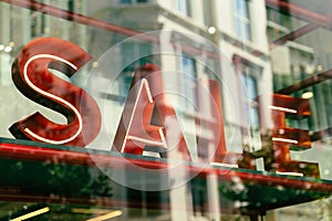Sale sign in shop window with reflections photo