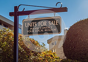 For Sale signs displayed outside of a new houses. Estate agent sign displayed on a street