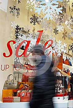 Sale signs in shop window, big reductions