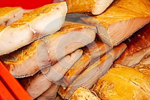 Sale of smoked Kamchatka fish. Far Eastern seafood, natural smoked fish - inconnu salmon at the city Christmas market