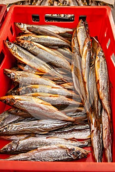 Sale of smoked Kamchatka fish. Far Eastern seafood, natural smoked fish - smelt salmon at the city Christmas market