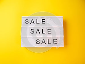 Sale store concept with lightbox text on yellow background