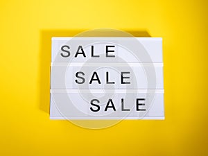 Sale store concept with lightbox text on yellow background