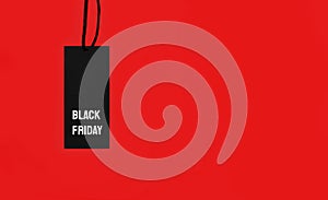 Sale tag with Black Friday inscription on red background.