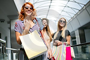 Sale and travel, happy people concept. Women with shopping bags in the ctiy