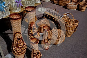 Sale of various wicker products at a peasant fair on a city street.