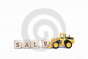 Sale wooden cubes with yellow truck isolate on white background
