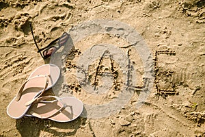 Sale written in the sand on a beach