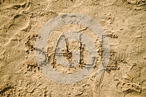 Sale written in the sand on a beach