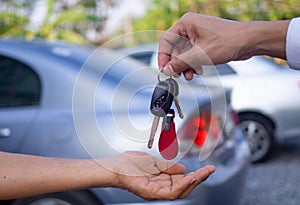Sales agencies are selling cars and giving keys to new owners. sell car or rental car photo