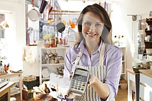 Sales Assistant In Homeware Store With Credit Card Machine