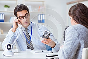 The sales assistant showing cameras to client in shop