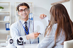 The sales assistant showing cameras to client in shop