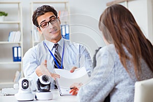 The sales assistant showing cameras to client in shop