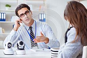 The sales assistant showing cameras to client in shop