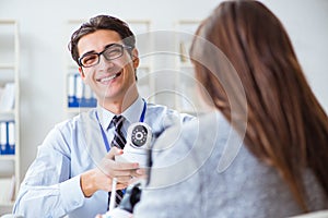 The sales assistant showing cameras to client in shop