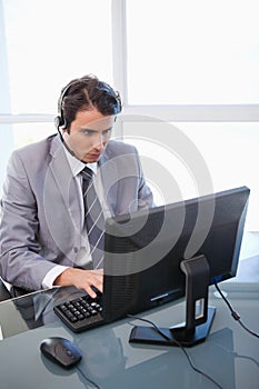 A sales assistant working with a monitor