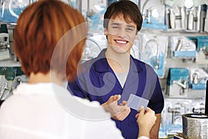 Sales clerk receiving credit card photo