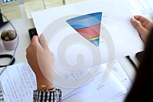 Sales funnel shown on a print by a professional young woman