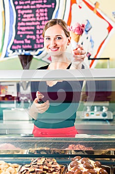 Sales girl handing wafer of ice cream over counter