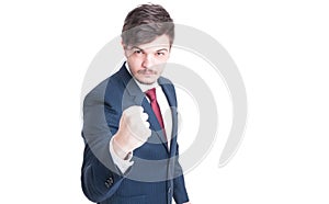 Sales man wearing suit showing fist like fighting