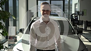 Sales manager car, agent in dealership hold notepad and smile look at camera, portrait. 30s