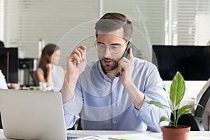 Sales manager consulting client talking on phone in office photo