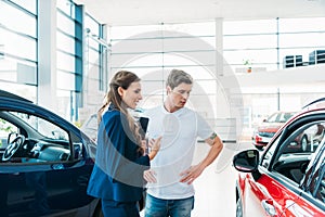 Sales manager describing car to customer