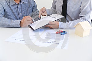 Sales manager giving advice application form document, considering mortgage loan offer for car and house insurance