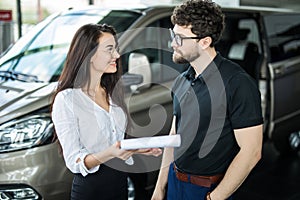 Sales manager showing to happy customer a car he won. Dealership, car rental
