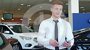 Sales manager shows car key at the dealership