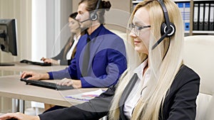 Sales marketing team in the office talking on the headphone set