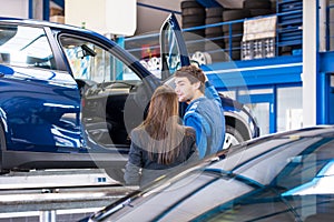 Sales mechanic shows a car to a prospected buyer