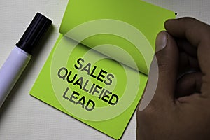 Sales Qualified Lead - SQL text on sticky notes isolated on office desk