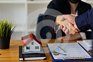 Sales representatives shake hands with customers and offer home purchase contracts to purchase current homes and leases offer home
