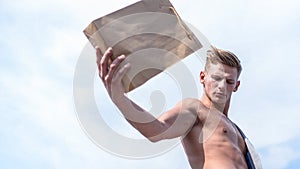 Sales season. Eco products shop. Man muscular athlete hold shopping bag sky background. Hot sales and discount. Guy