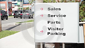 sales service parts visitor parking writing caption text silver black red sign 148