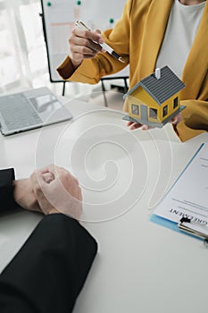 Sales staff discuss home details with customers before agreeing to sign a sales contract, buying and selling real estate, making