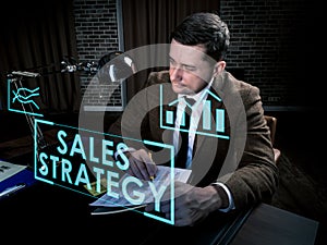 Sales strategy info concept. Man works late at the table.