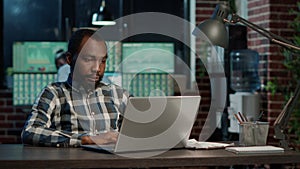 Sales trader working on stock market economy with laptop