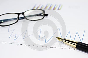 Sales volume charts on the table with pen